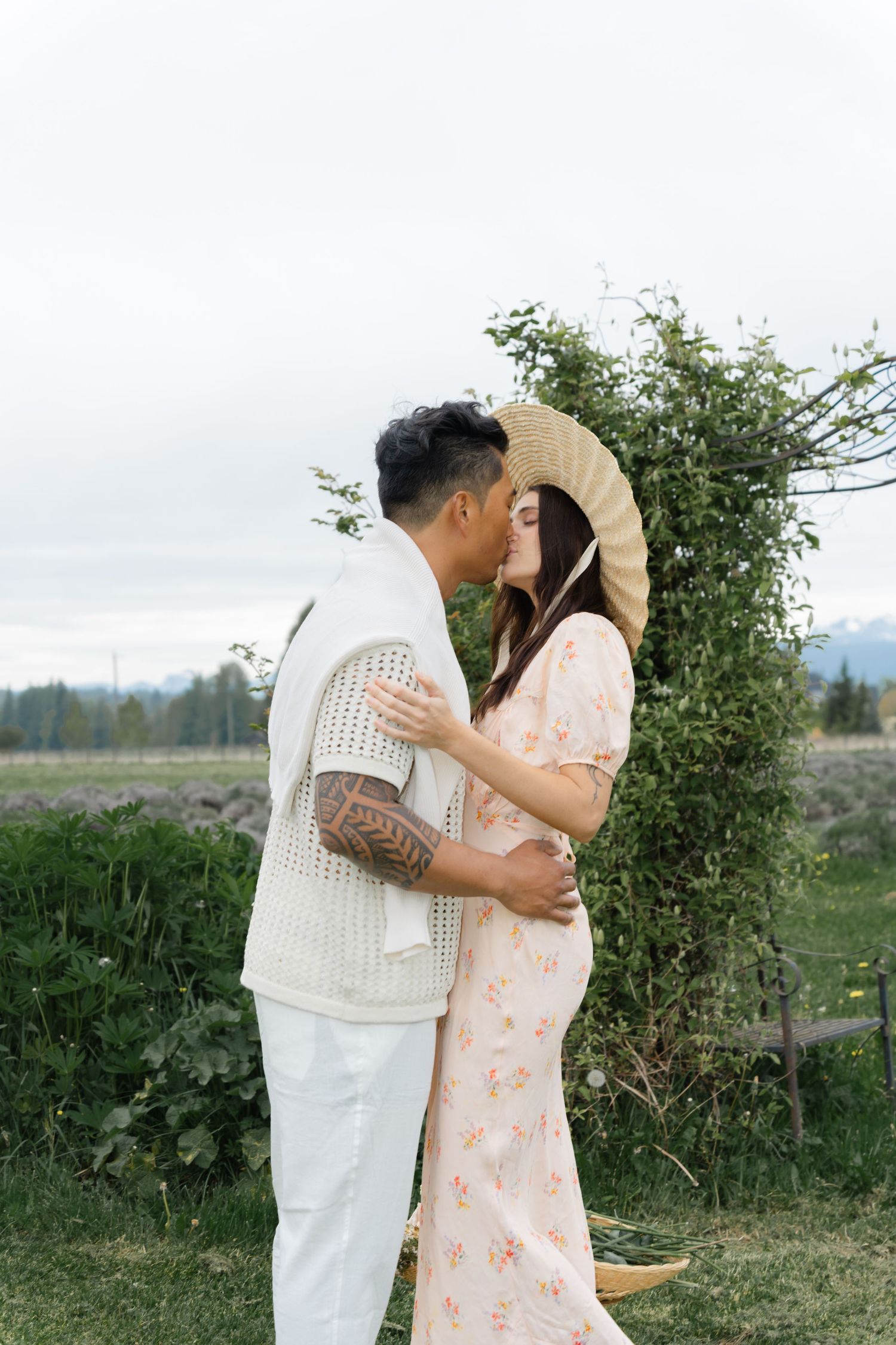 Romantic countryside photoshoot with couple in light summer clothing.