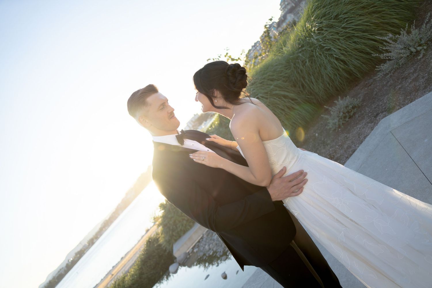 A romantic sunset embrace during a beach wedding photoshoot at Inn at Laurel Point. Victoria B.C