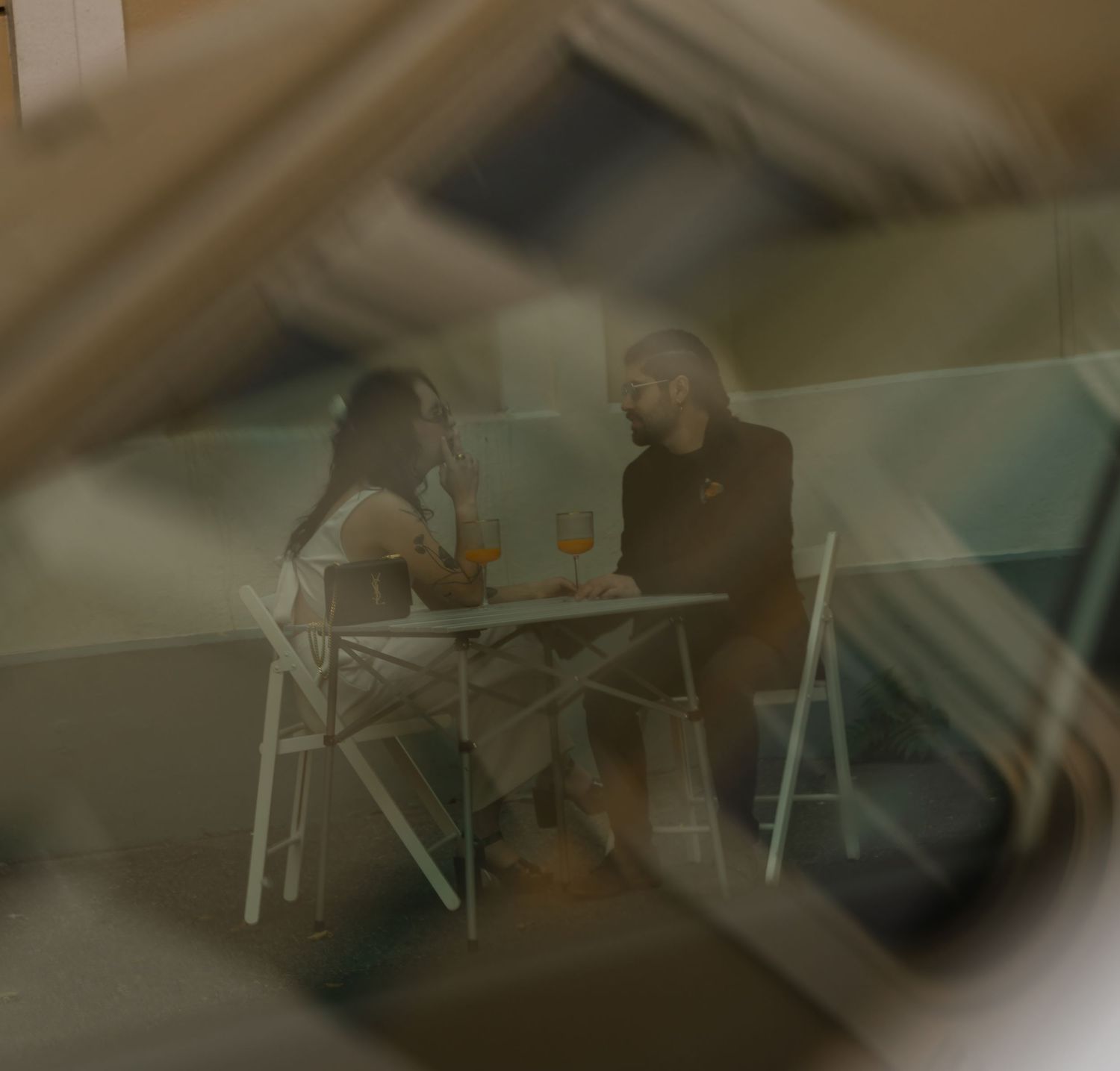 Blurred sequence of outdoor seating arrangements at dusk.