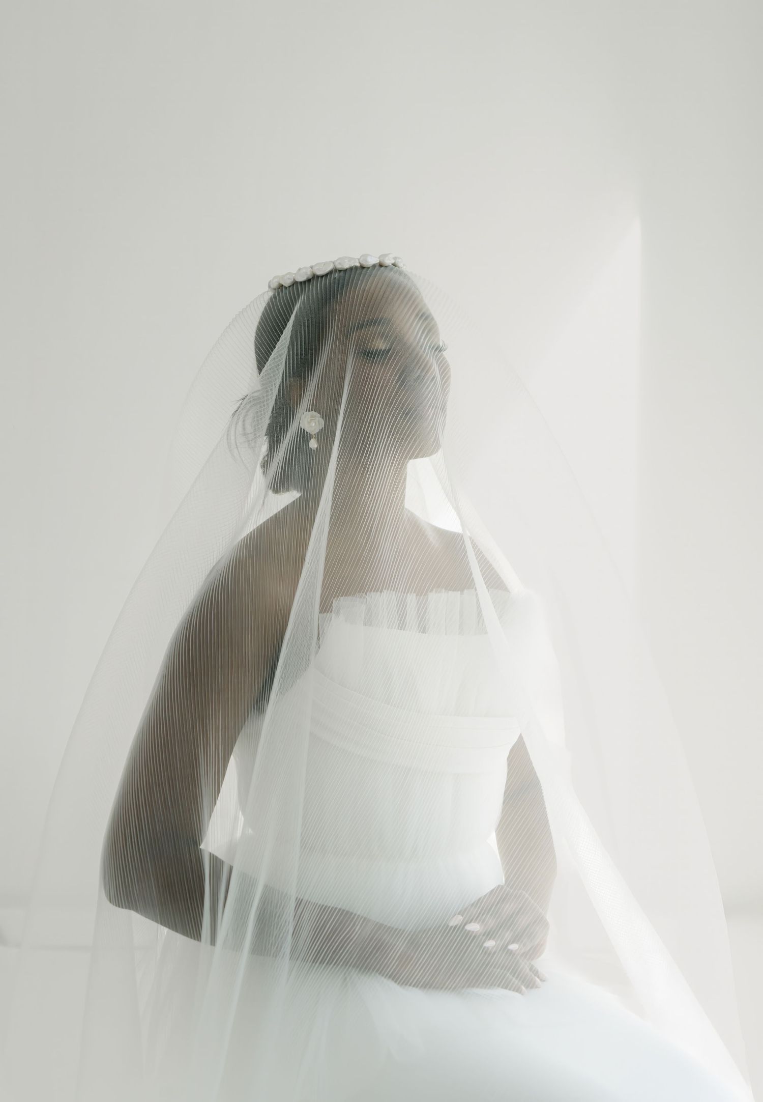 Ethereal sequence of artistic portrait shots with flowing white tulle veil creating a dreamy atmosphere.