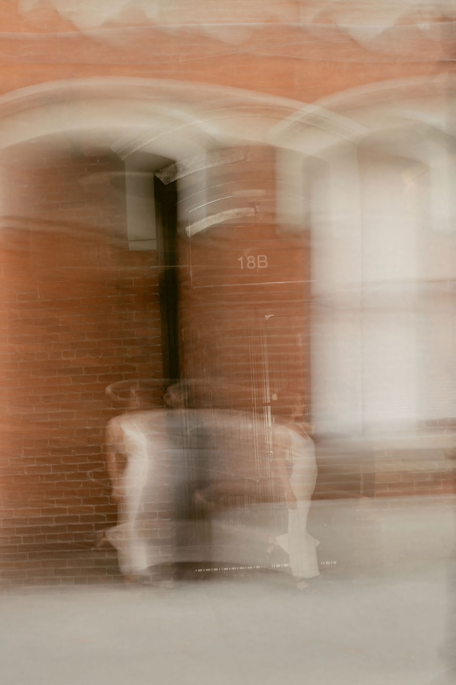 Blurred vintage effect hallway interior of brick building with doors and windows.