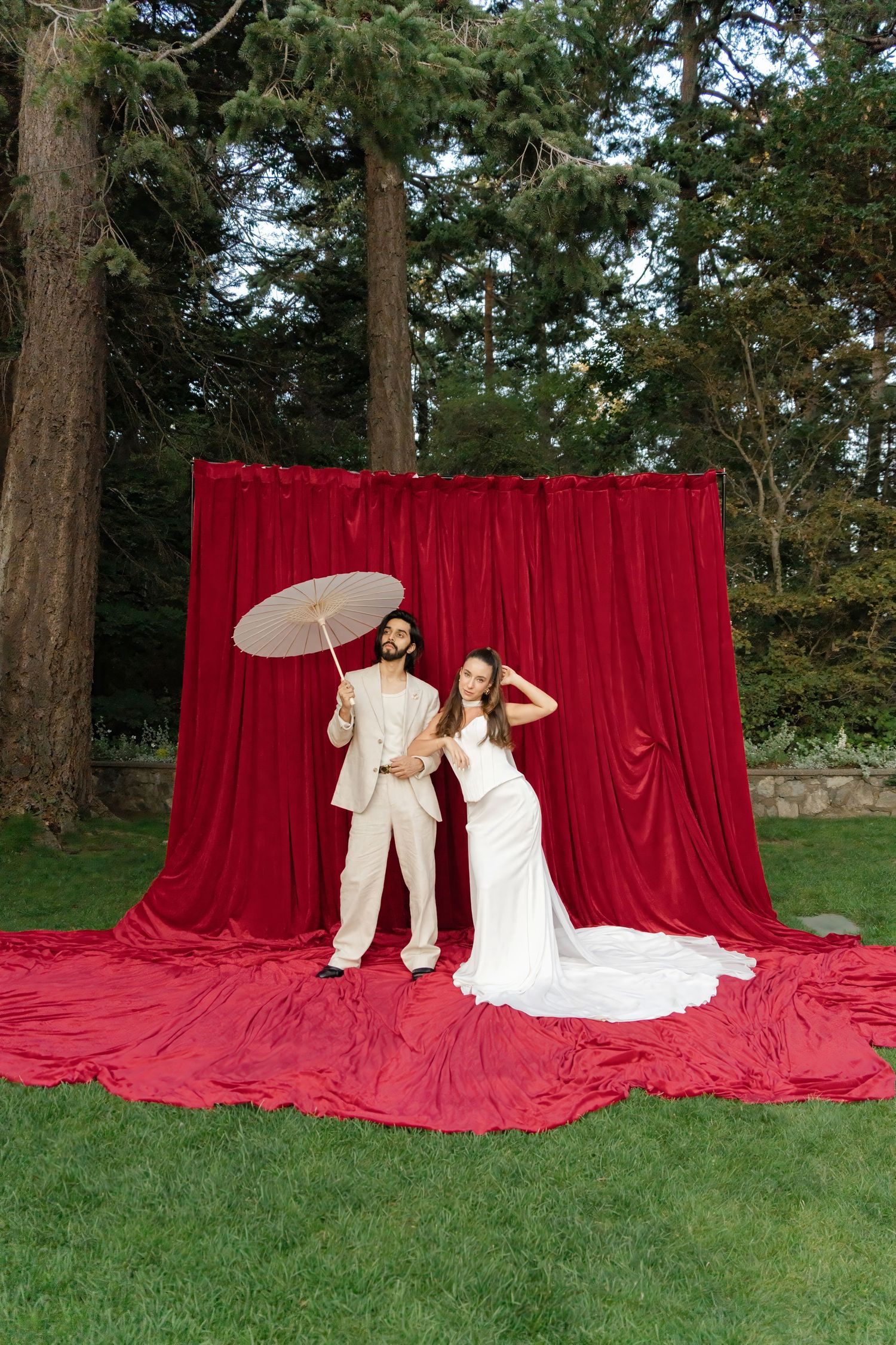 A wedding photo sequence showing a couple posing against a dramatic red velvet backdrop outdoors in a wooded setting.