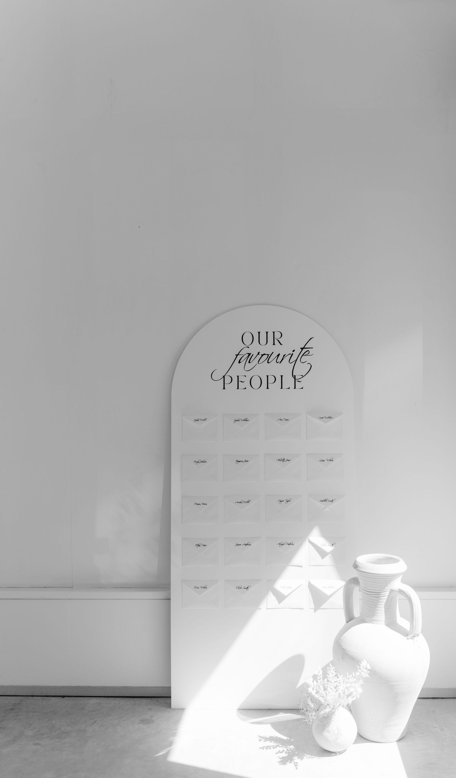 Clean white wedding seating chart display with elegant typography.