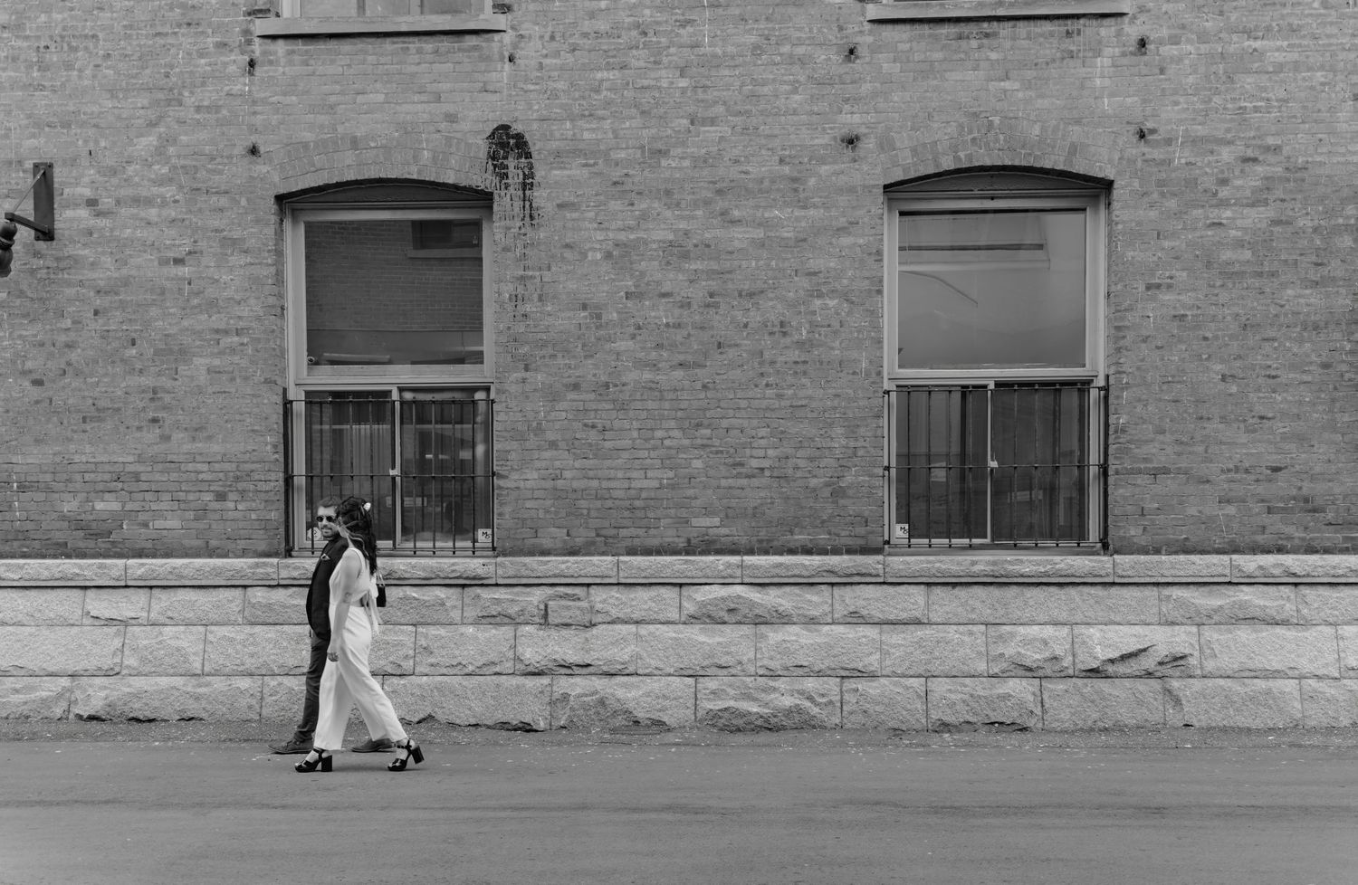 Wide panoramic view of a brick building exterior with multiple windows at Downtown Victoria.