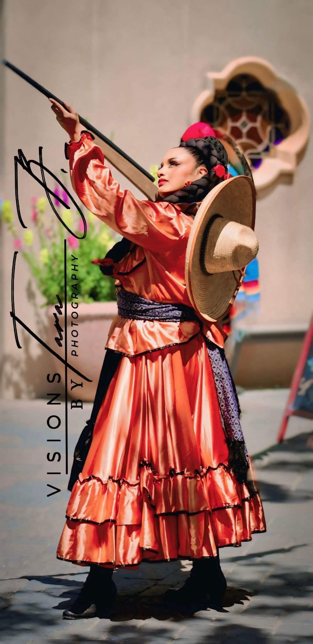 Dancer in vibrant traditional attire performing gracefully, captured mid-motion during a cultural celebration.