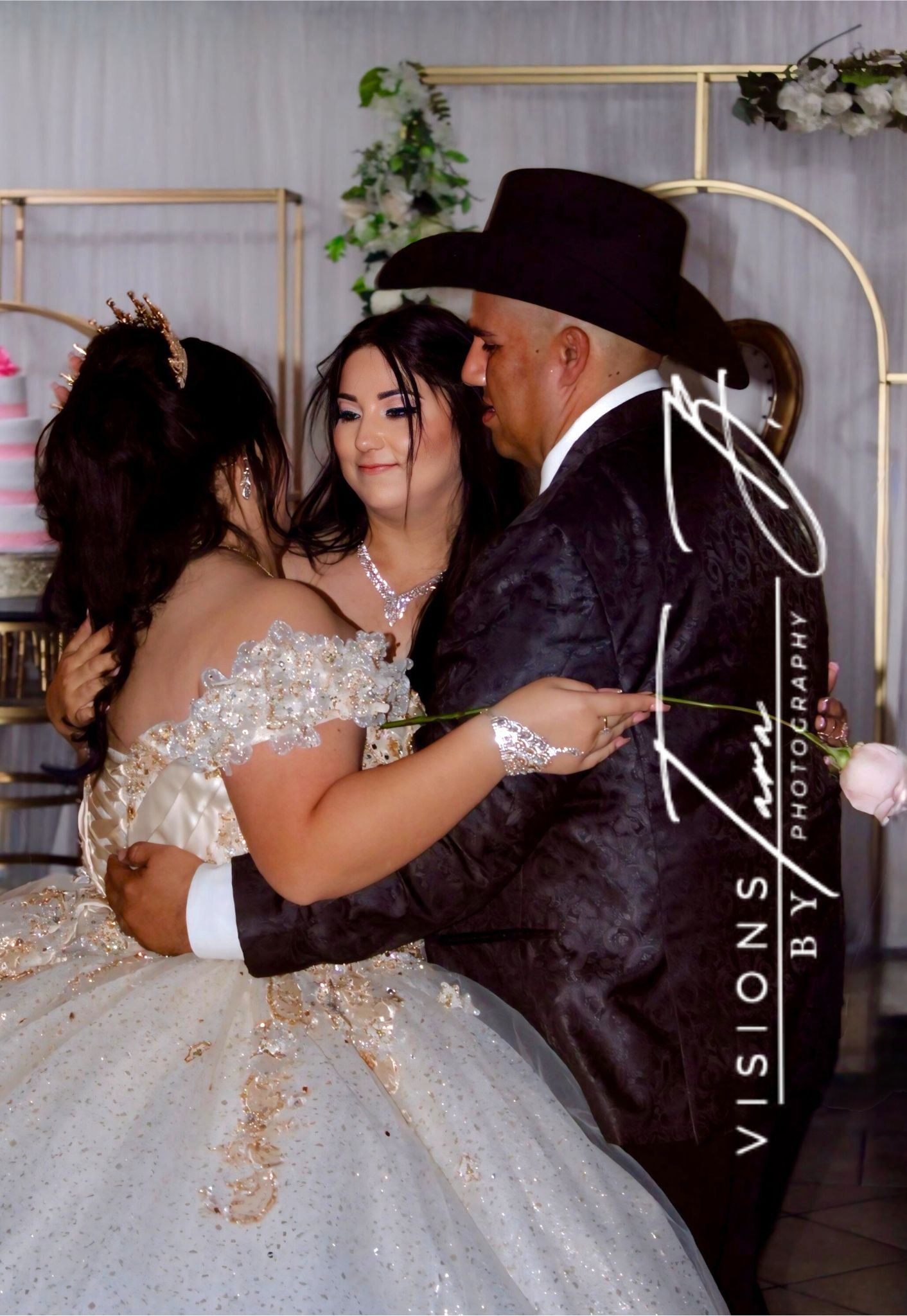 Quinceañera dancing with her family on a decorated dance floor, sharing a joyful and emotional celebration moment.