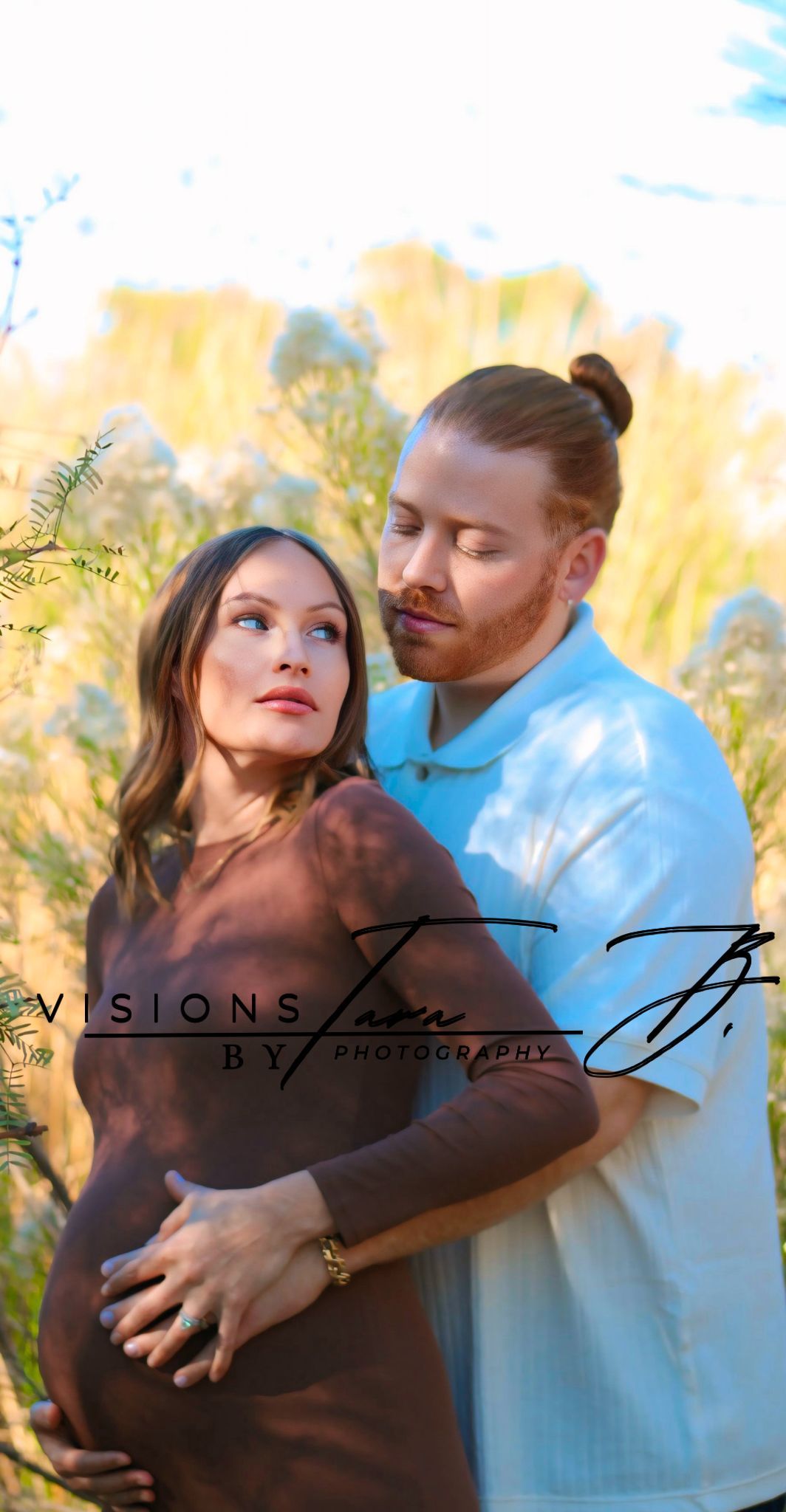 Expecting couple holding each other in warm golden light, smiling as they cradle the baby bump during a peaceful maternity moment.