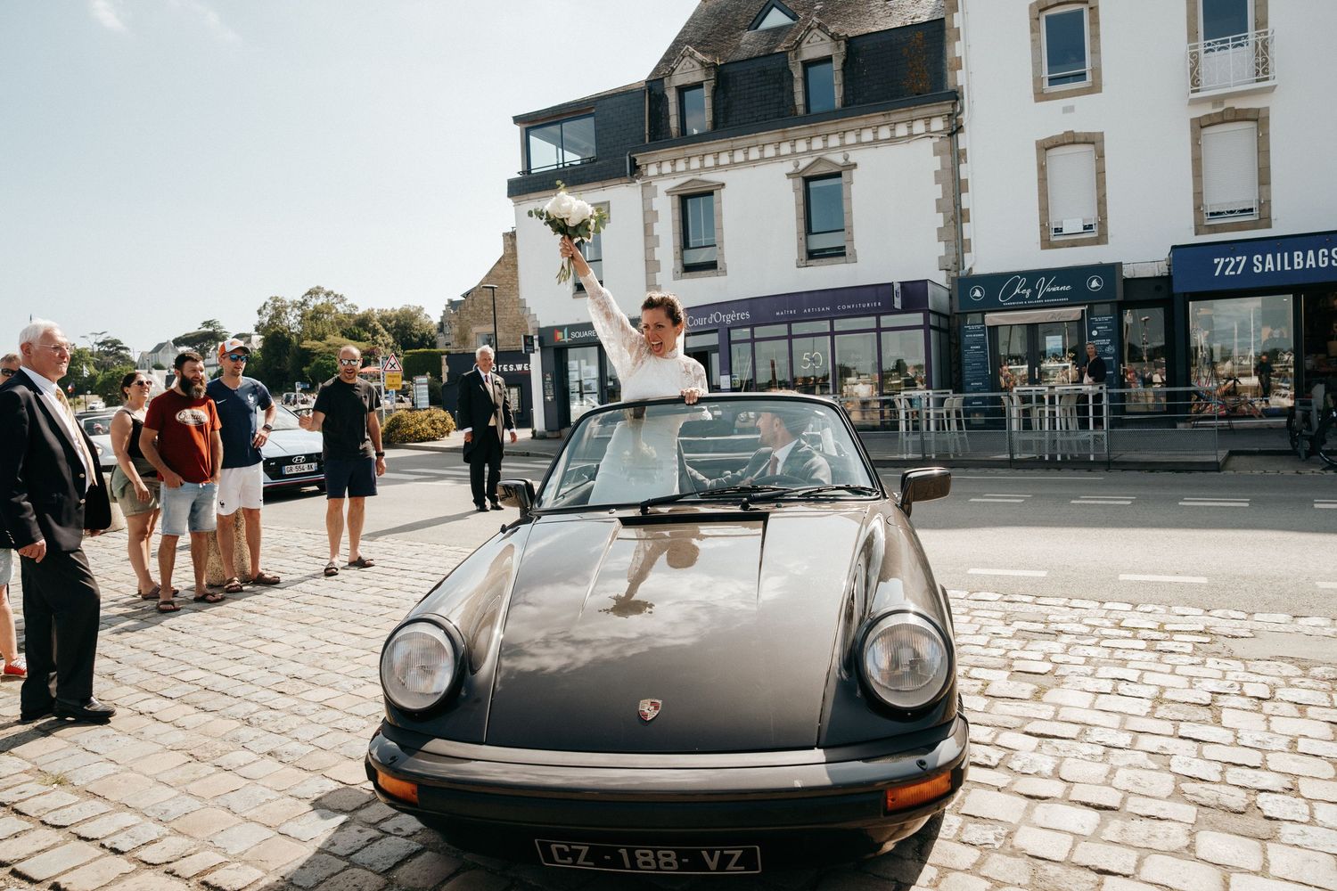 Mariée saluant depuis une voiture ancienne, mariage à la Trinité-sur-Mer