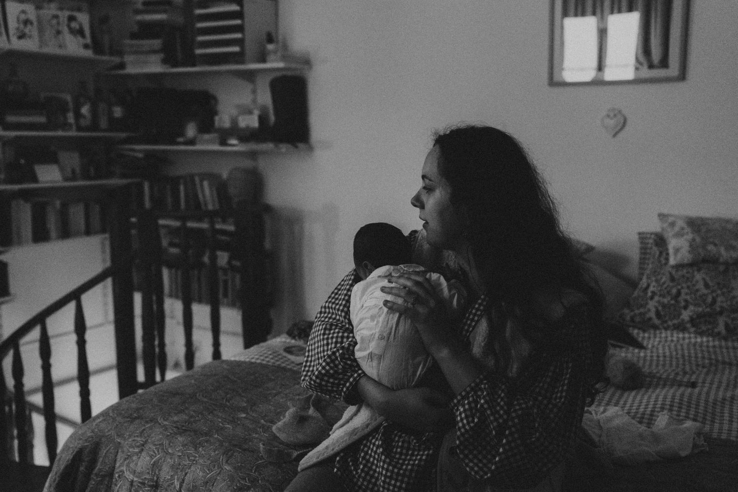 Mère tenant son nouveau-né sur un lit, noir et blanc