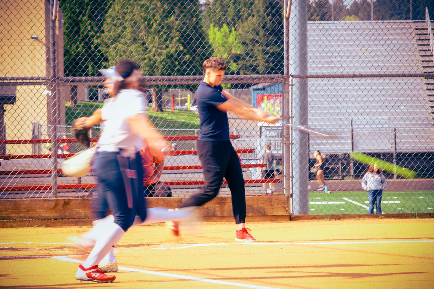 Baseball players in motion on a sunny field during a game.