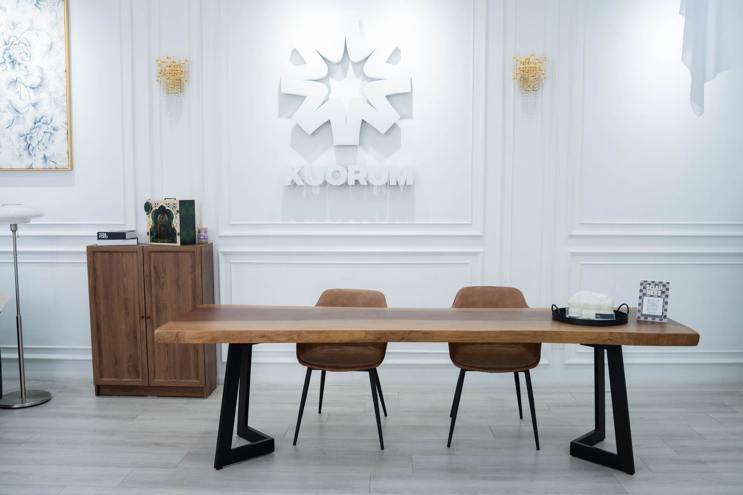 Modern dining room interior with white walls, wooden table, brown chairs and contemporary pendant lighting.