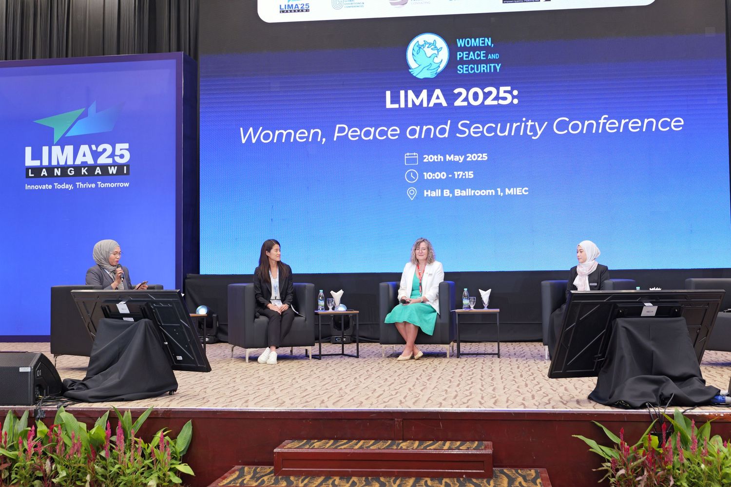 Panel discussion at LIMA 2025 Women, Peace and Security Conference with speakers seated on stage.