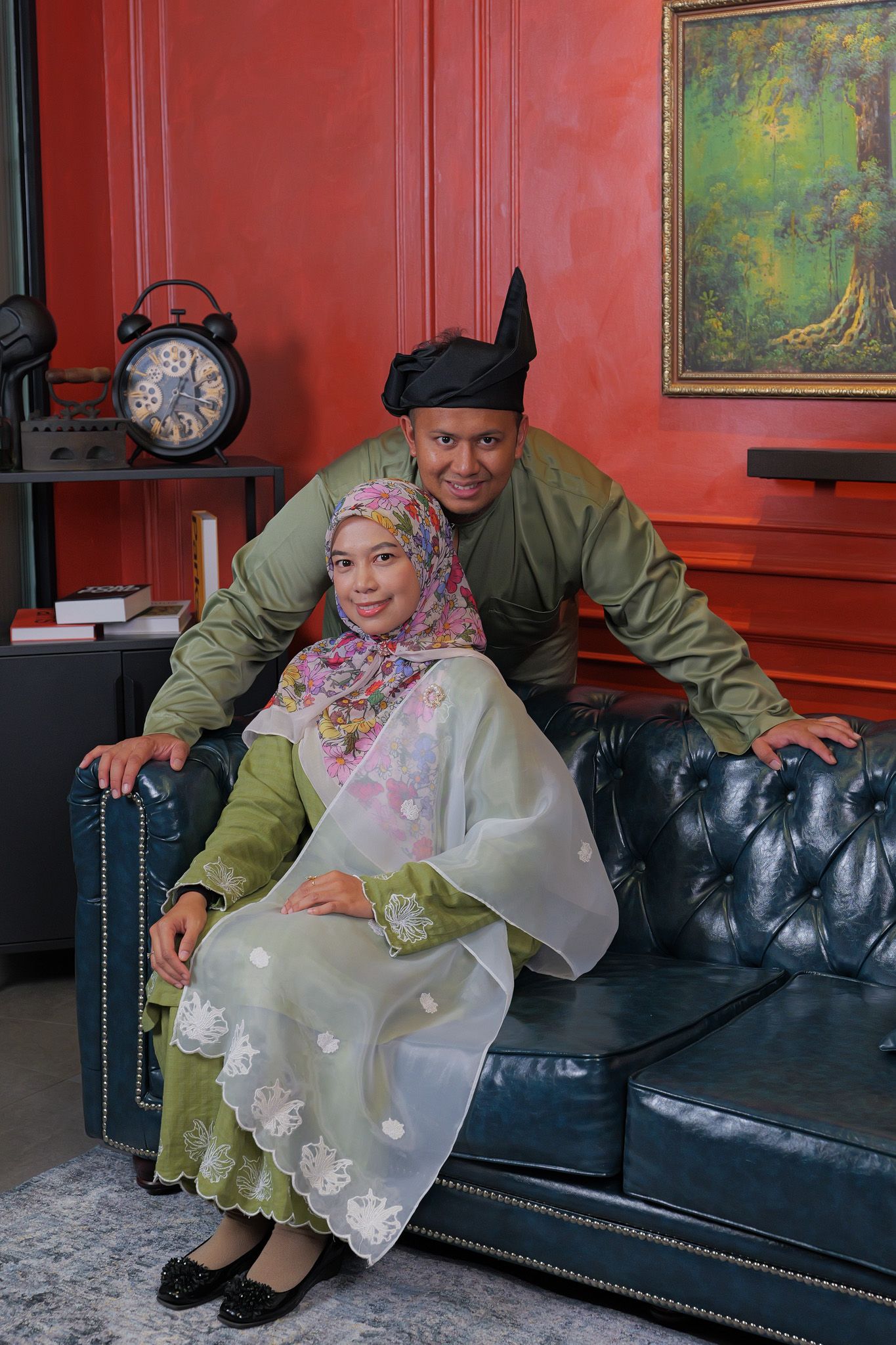 Three photos show a couple sitting together on a black leather couch against a red wall with artwork in the background.