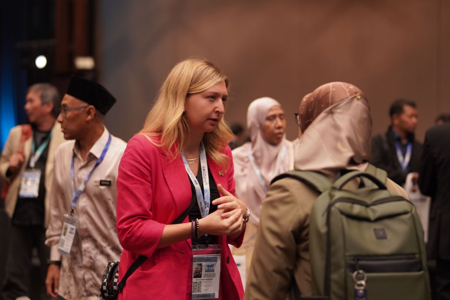 Conference attendees network and mingle during event break.