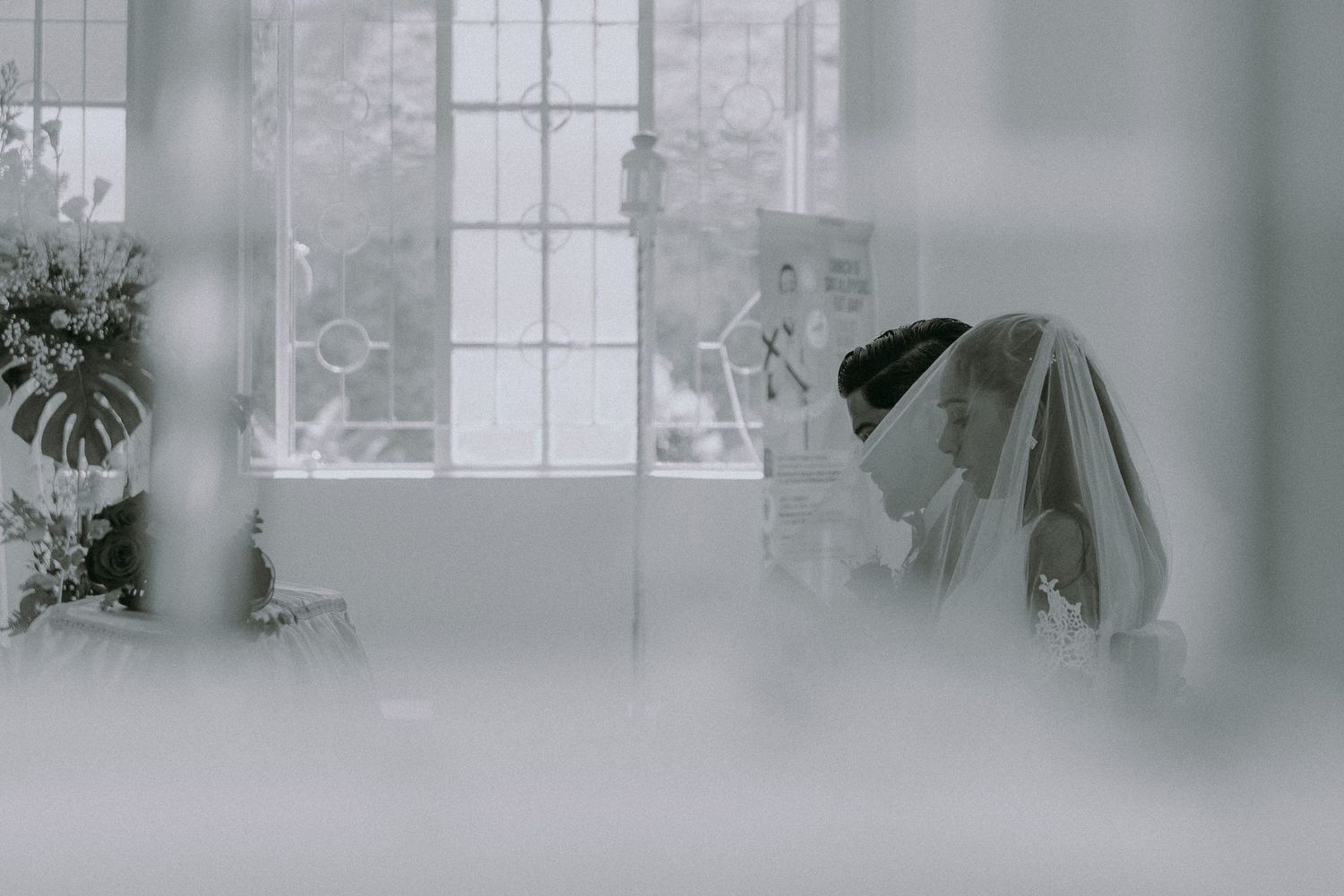 A row of blurry window frames in a serene indoor setting creates a moody atmospheric effect.