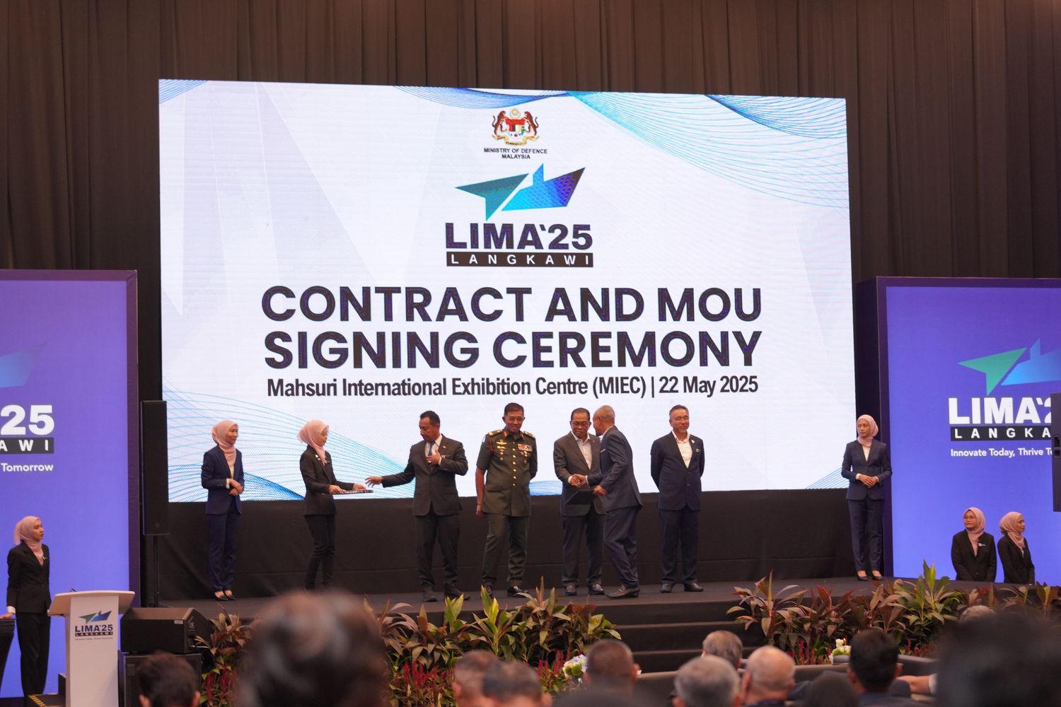 Contract and MoU signing ceremony stage setup with LIMA25 branding and corporate banners.