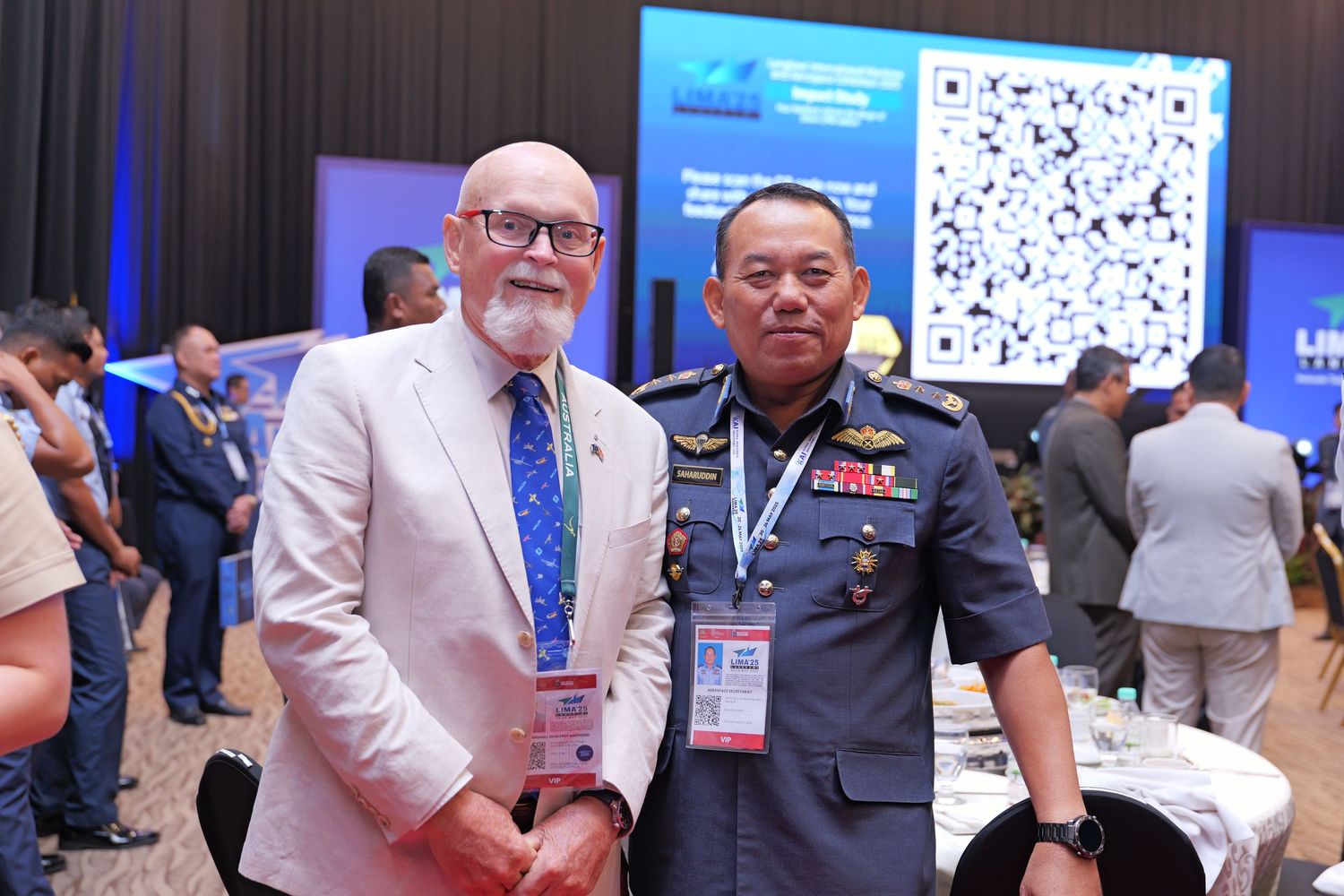Two conference attendees networking at an aerospace industry event.