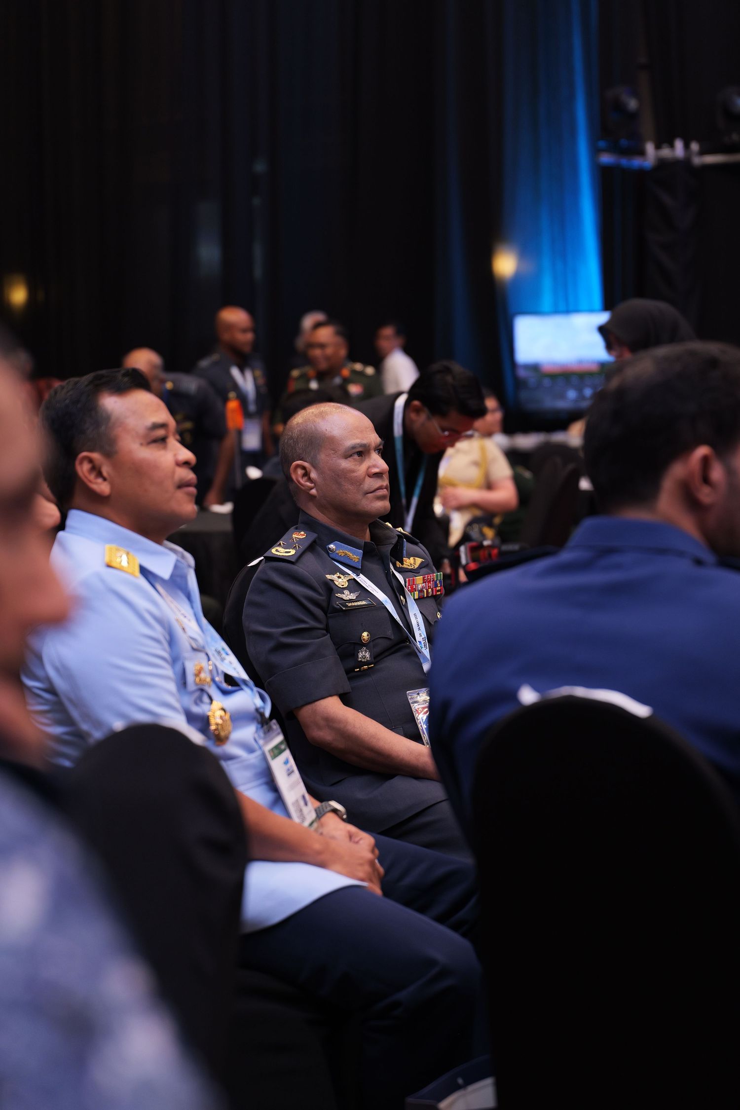 Military and service members seated in an audience during a formal conference or ceremony.