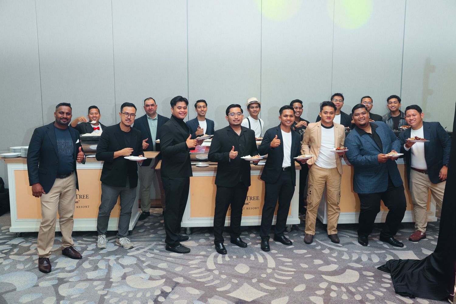 Group of men in formal attire holding awards and posing together at a corporate recognition event.