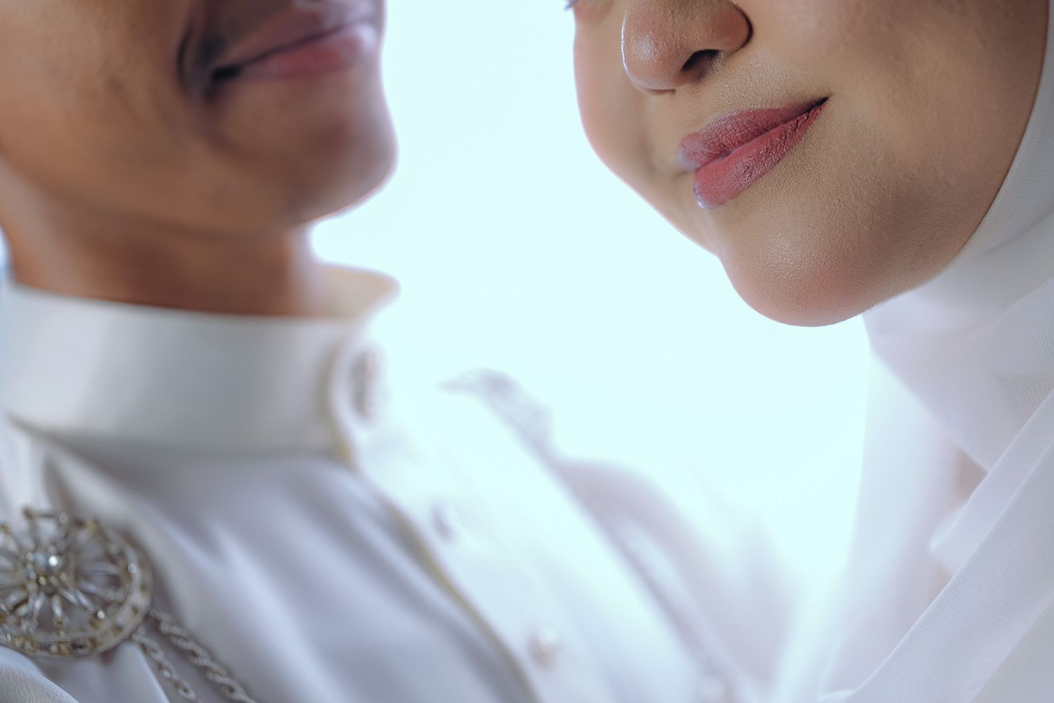 Close-up wedding photography sequence showing tender moments between a couple in white attire.