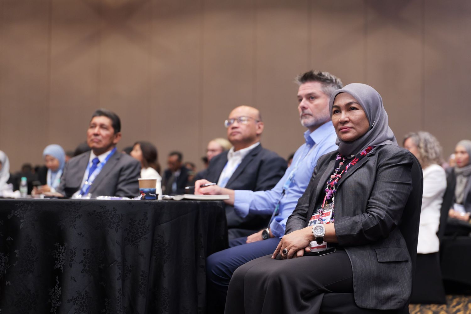 Conference attendees listening attentively during a professional business event.