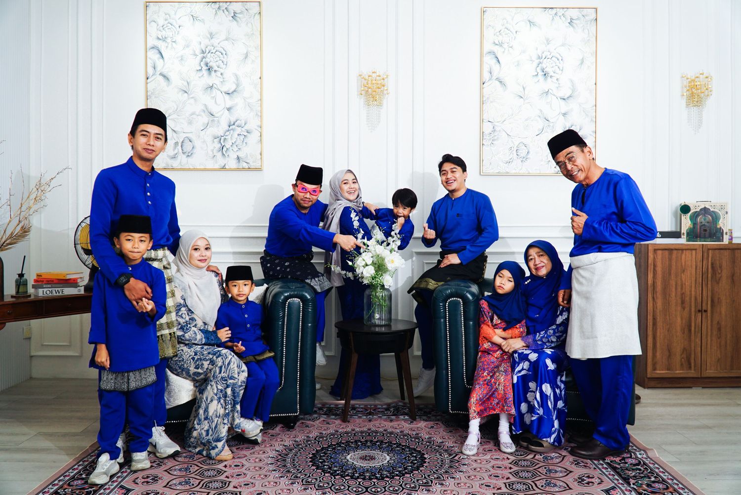 A group in blue uniforms visits with elderly residents at a care facility during a community outreach program.