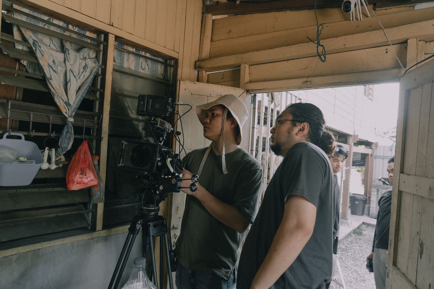 Production team operating professional camera equipment during a film shoot.