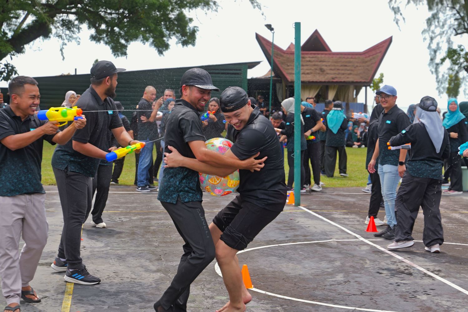 Participants playing outdoor team building rugby activity during a corporate sports day event.