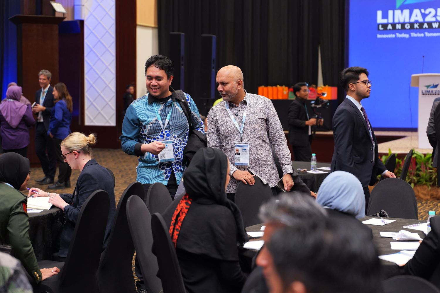 Attendees gather at a professional conference with LIMA23 branding visible in the background.