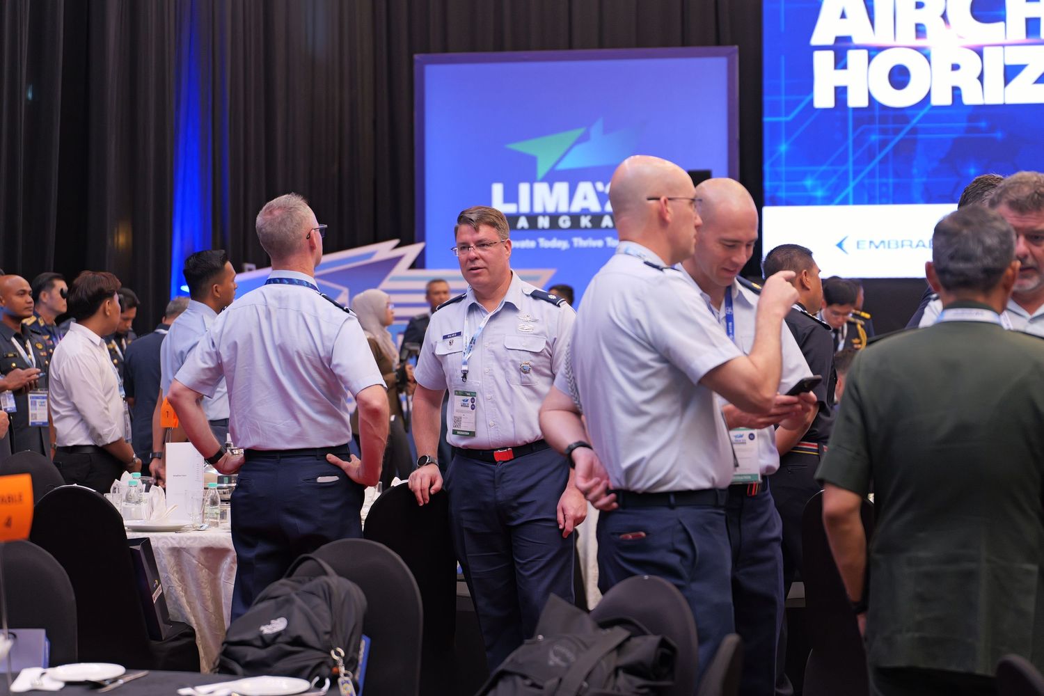 Military personnel gather at a conference with 