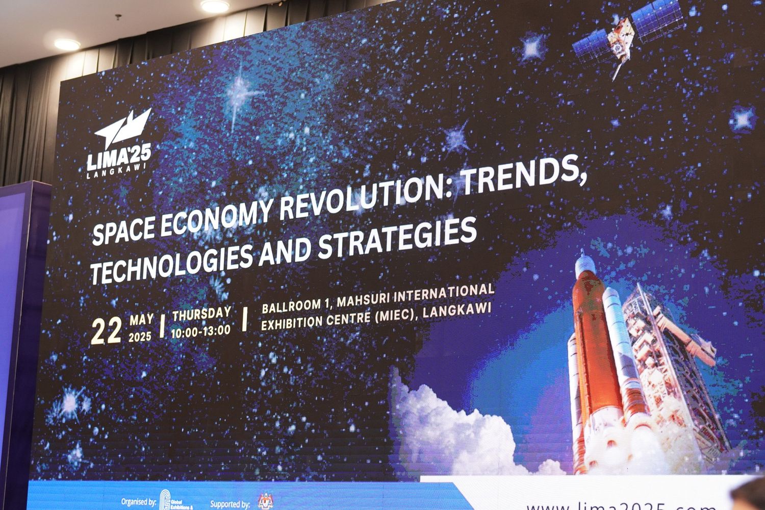 Conference banner showing 'Space Economy Revolution' with rocket and starry space background.