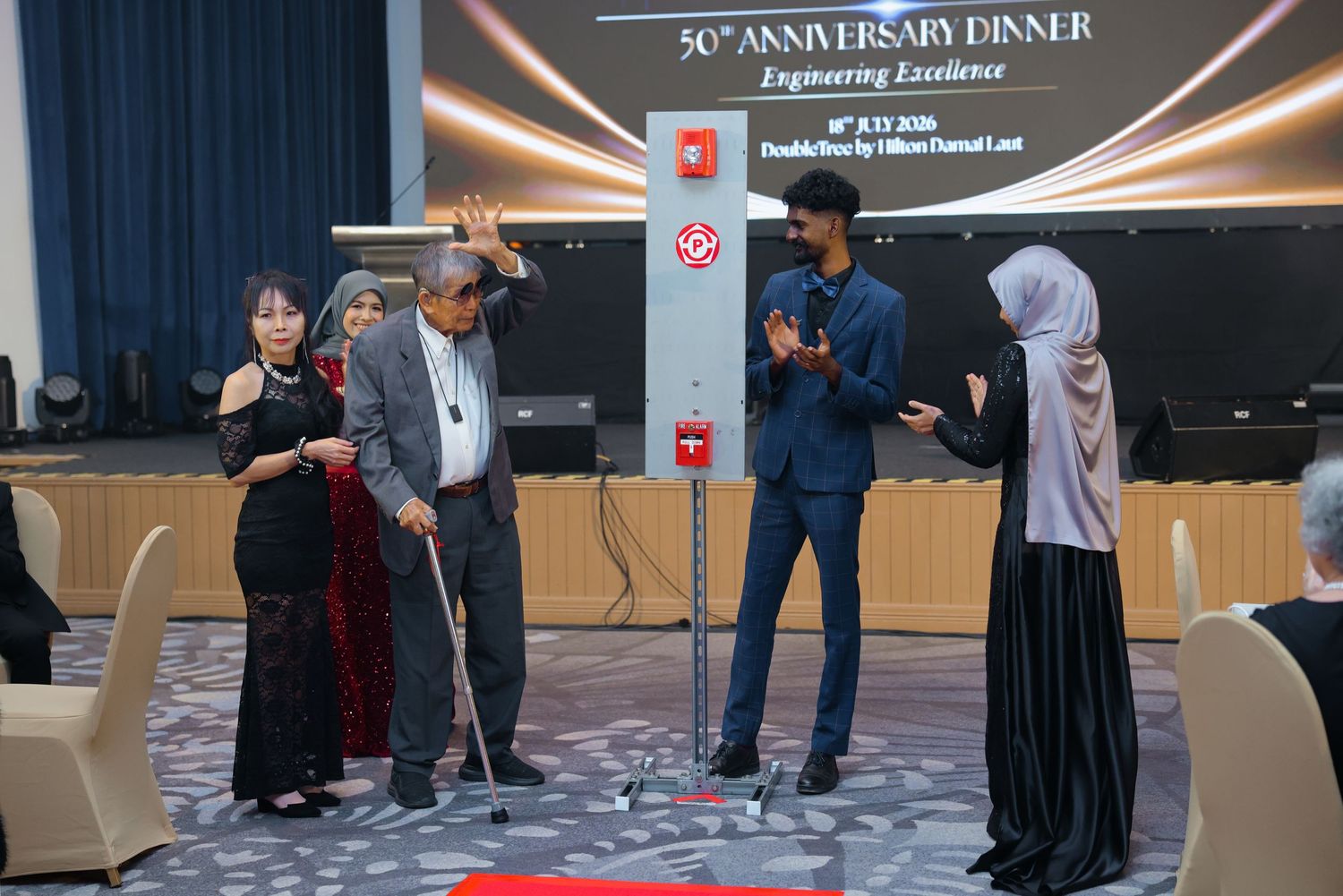 People participate in 50th Anniversary Dinner Engineering Excellence award ceremony on stage.