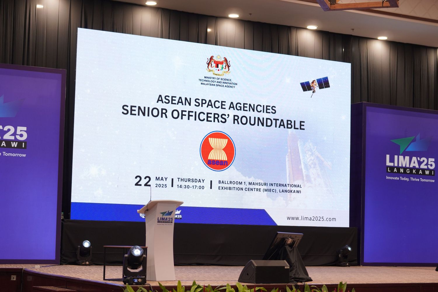 Large projection screen showing ASEAN Space Agencies Senior Officers' Roundtable event title with official logos.