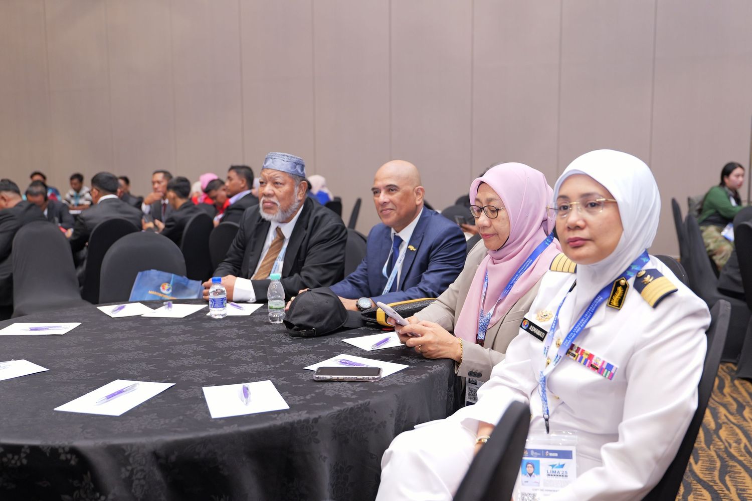 Professional delegates seated at round tables during an important conference session.
