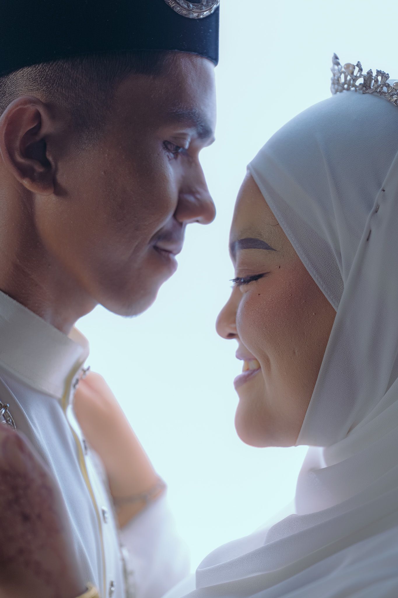 An intimate wedding portrait sequence showing a couple in white Islamic wedding attire against a bright background.