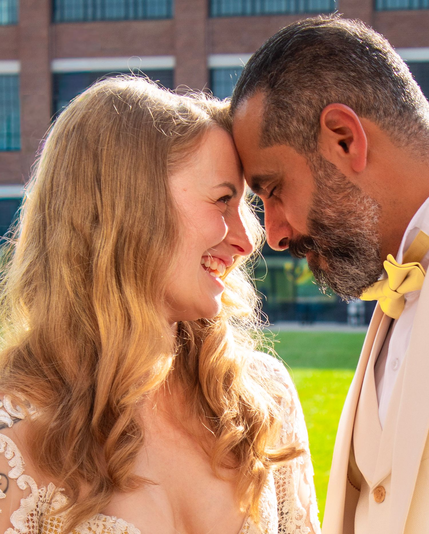 Romantic backlit couple portraits with golden sunlight filtering through trees.