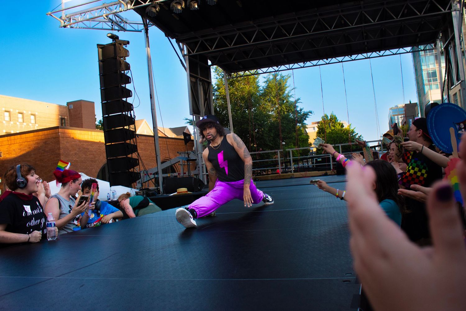 Dynamic stage performance with crowd watching during outdoor event.