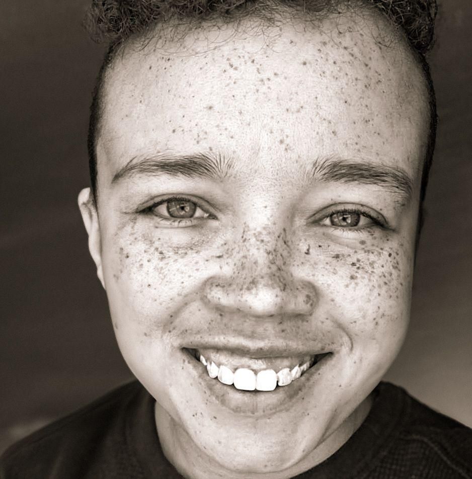 Black and white portraits showing joyful expressions and freckles.