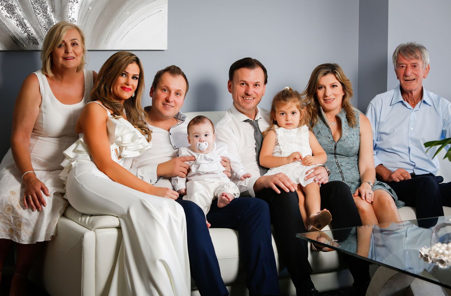 Series of elegant family photos showing different groupings and poses in a studio setting.