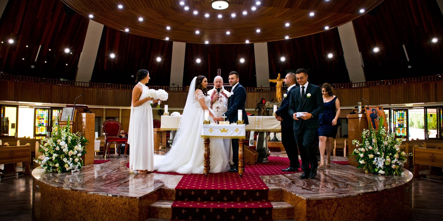 Wedding venue interior decorated with string lights and elegant seating arrangements.