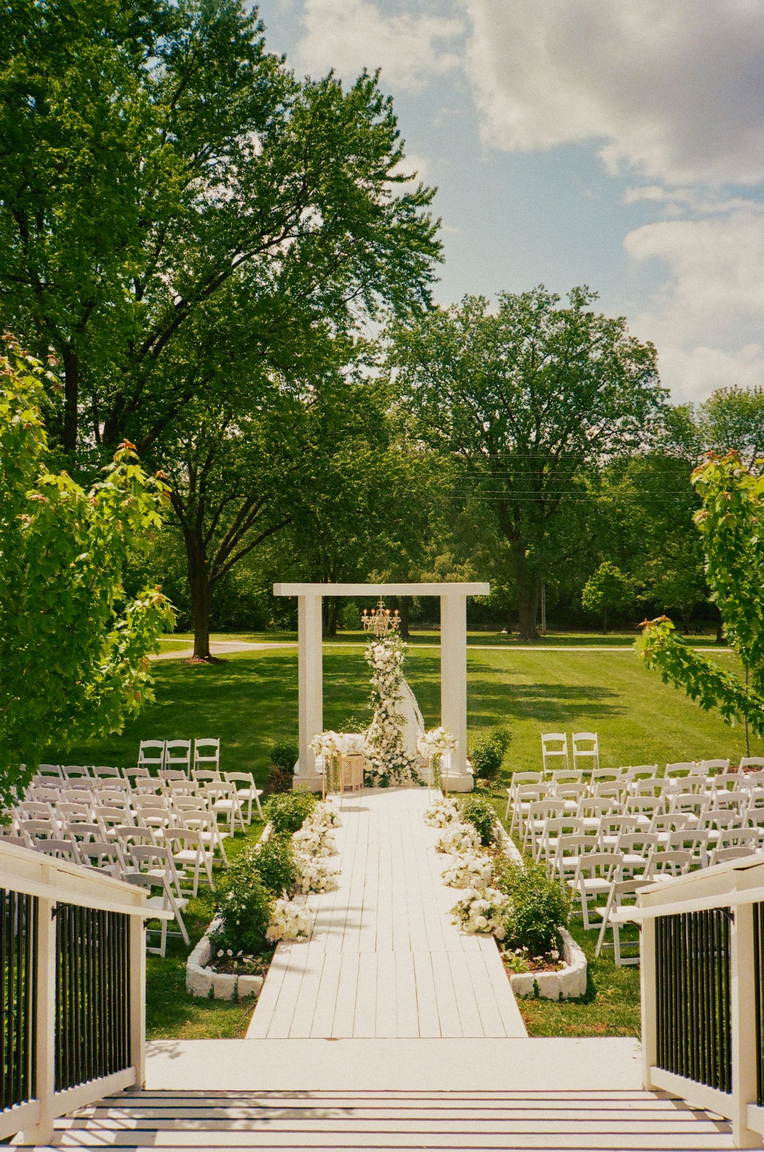 Floral walkway leads to a garden pavilion draped with a traditional parda for the Nikkah ceremony. At revelry675 batavia