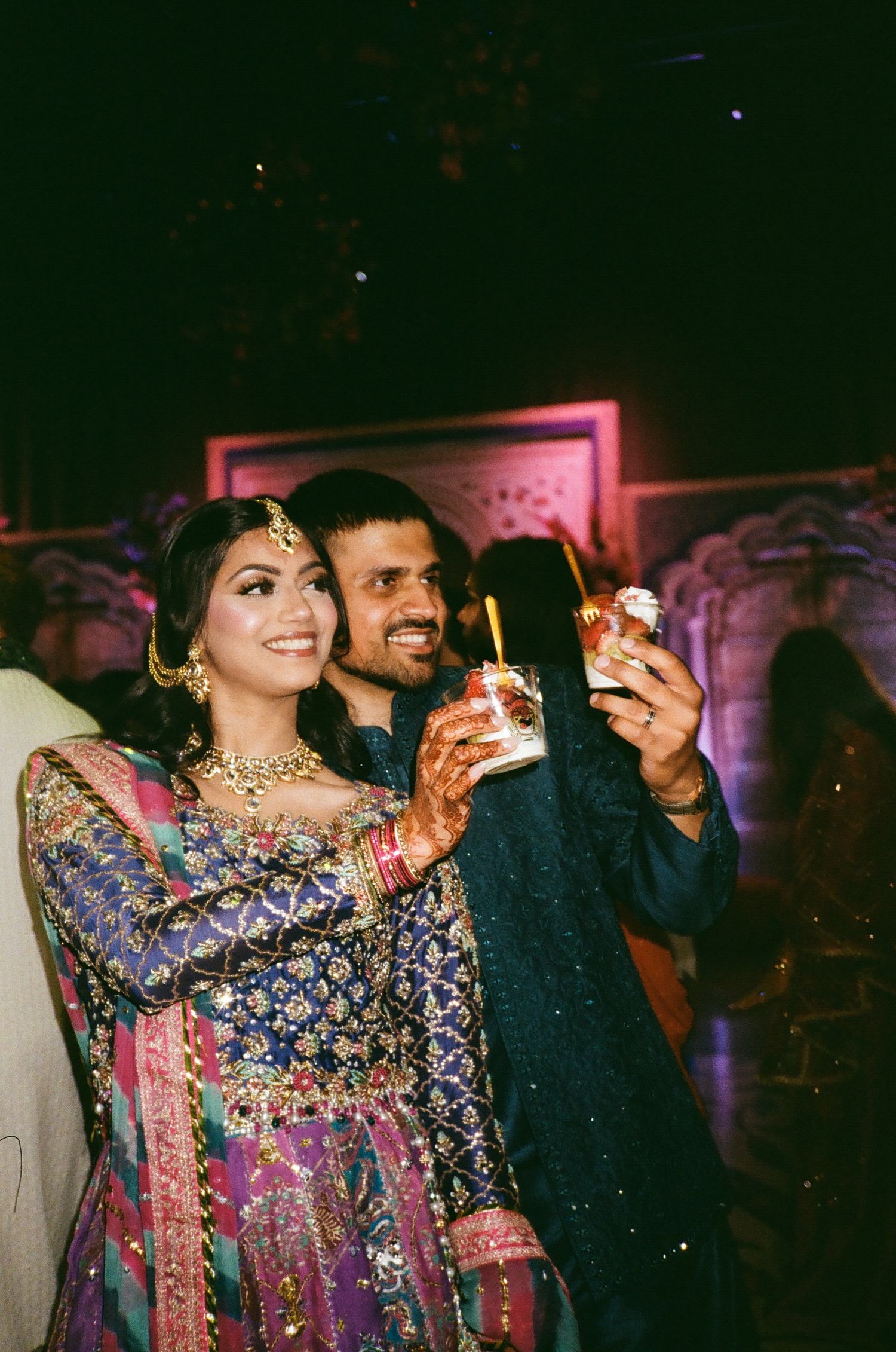 A Muslim Desi couple in bright Mehndi attire the bride looks gorgeous, radiating festive charm. the canvas venue