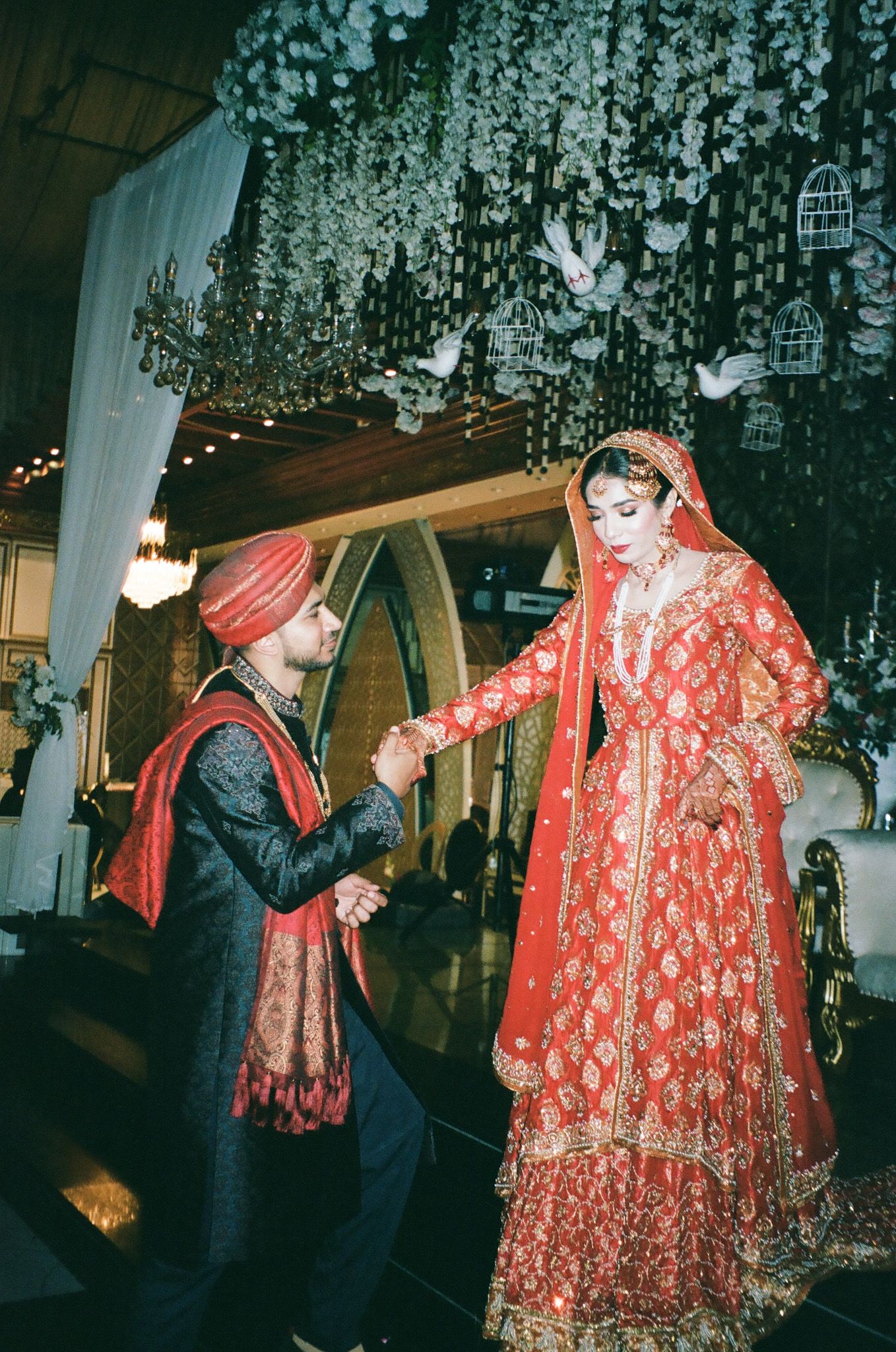 classic Desi wedding moment caught on nostalgic 35mm film. regal royal pose for asian weddings
south asia