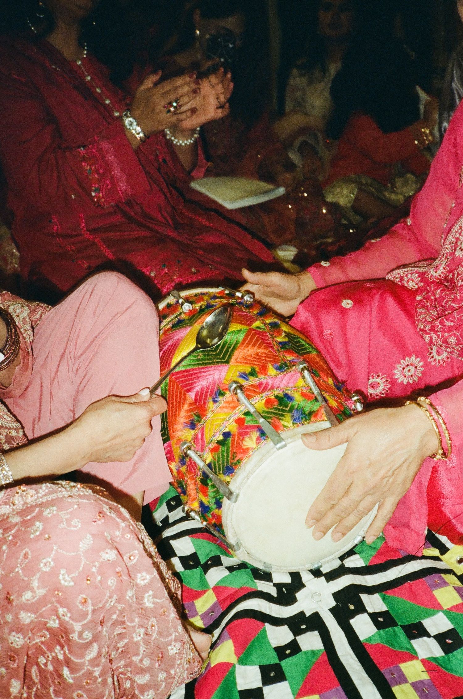 Vibrant Dholki celebration in Chicago suburbs—joyful music and colors come alive through authentic 35mm film photography.