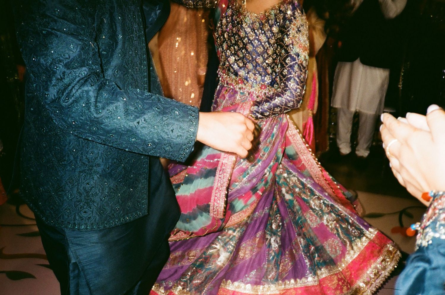 A couple dances joyfully at their Mehndi celebration, vibrant color captured beautifully on 35mm film! the canvas venue arlington heights