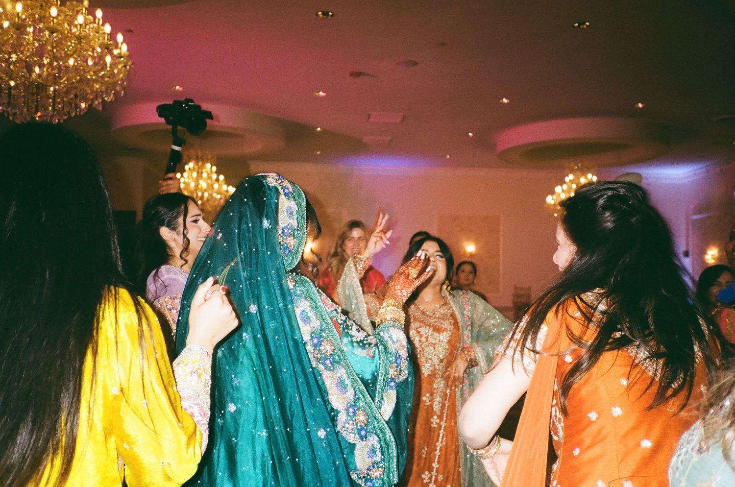 Colorful Mehndi dance party in a Chicago suburbs venue;  35mm film. shalimar banquet hall in addison illinois