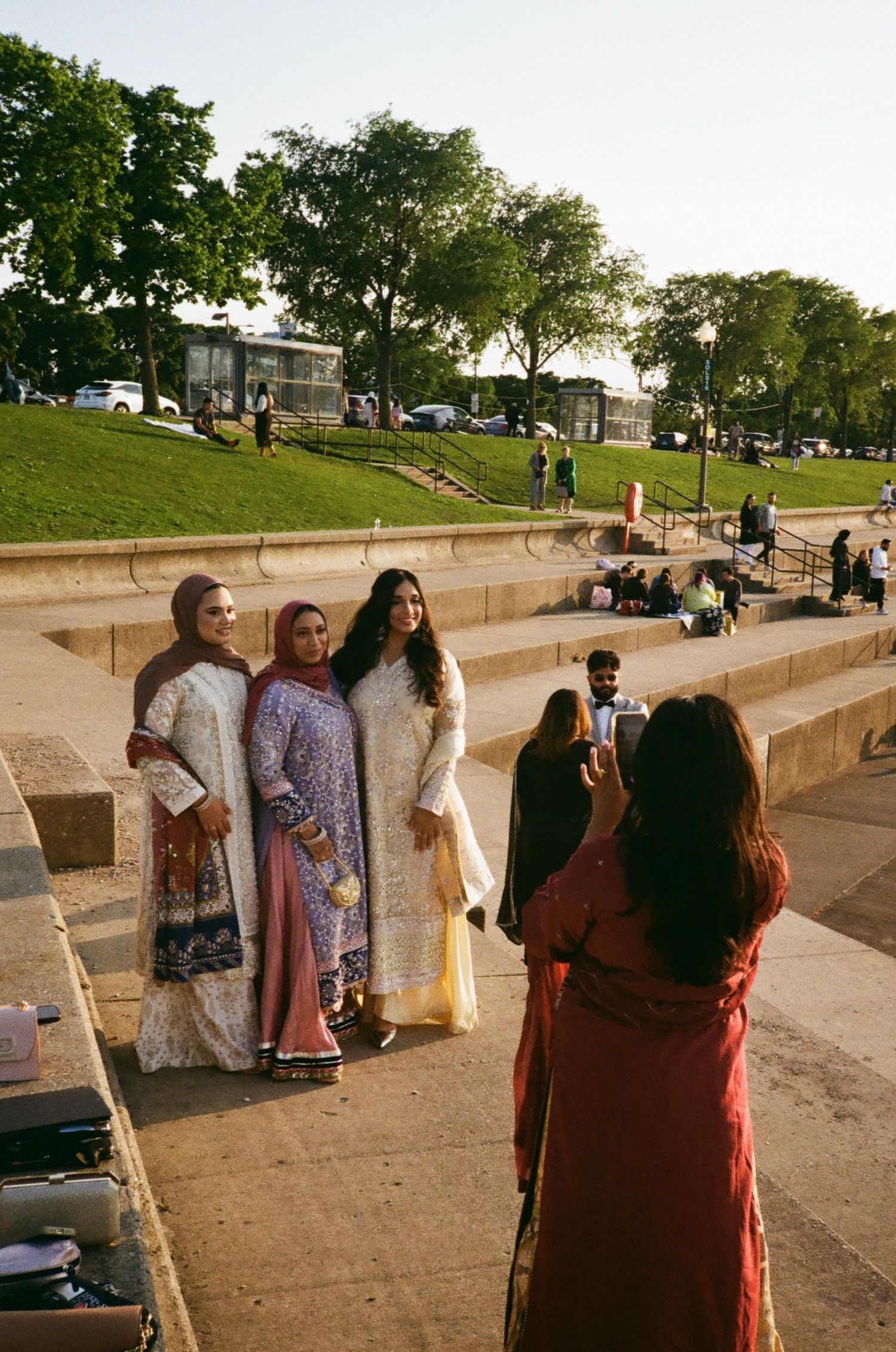 Candid moment of bridesmaids on Museum Campus steps in Chicago, 35mm film magic., desi outfits, chicago south asian, adler planetarium venue