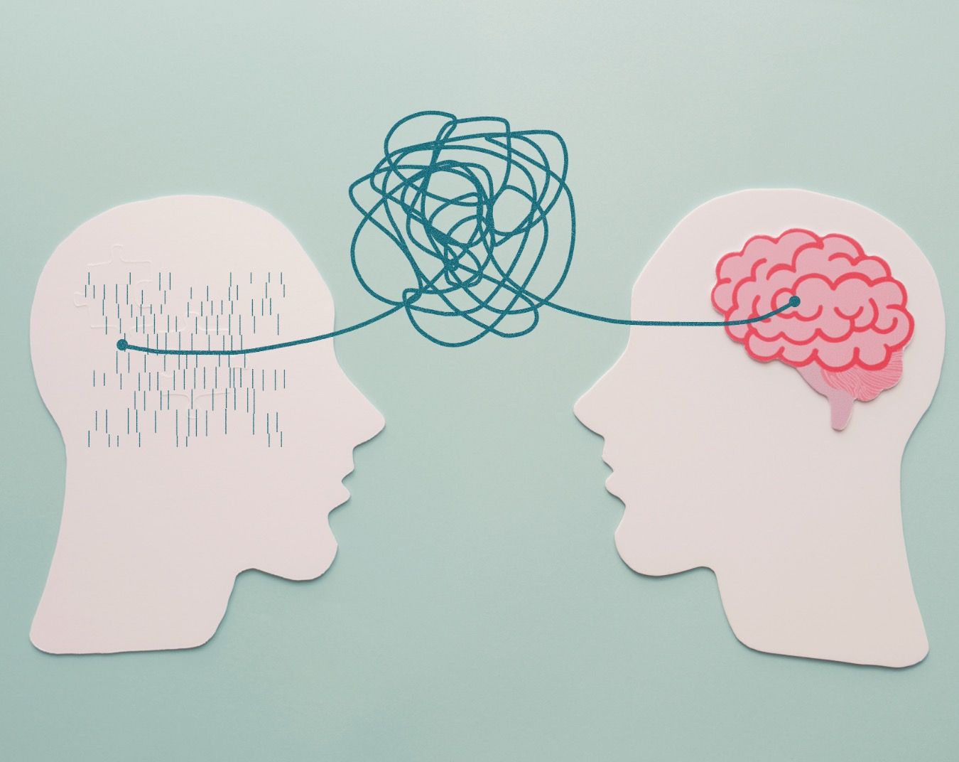 Paper cutout illustration showing two head silhouettes connected by a tangled line between their minds.