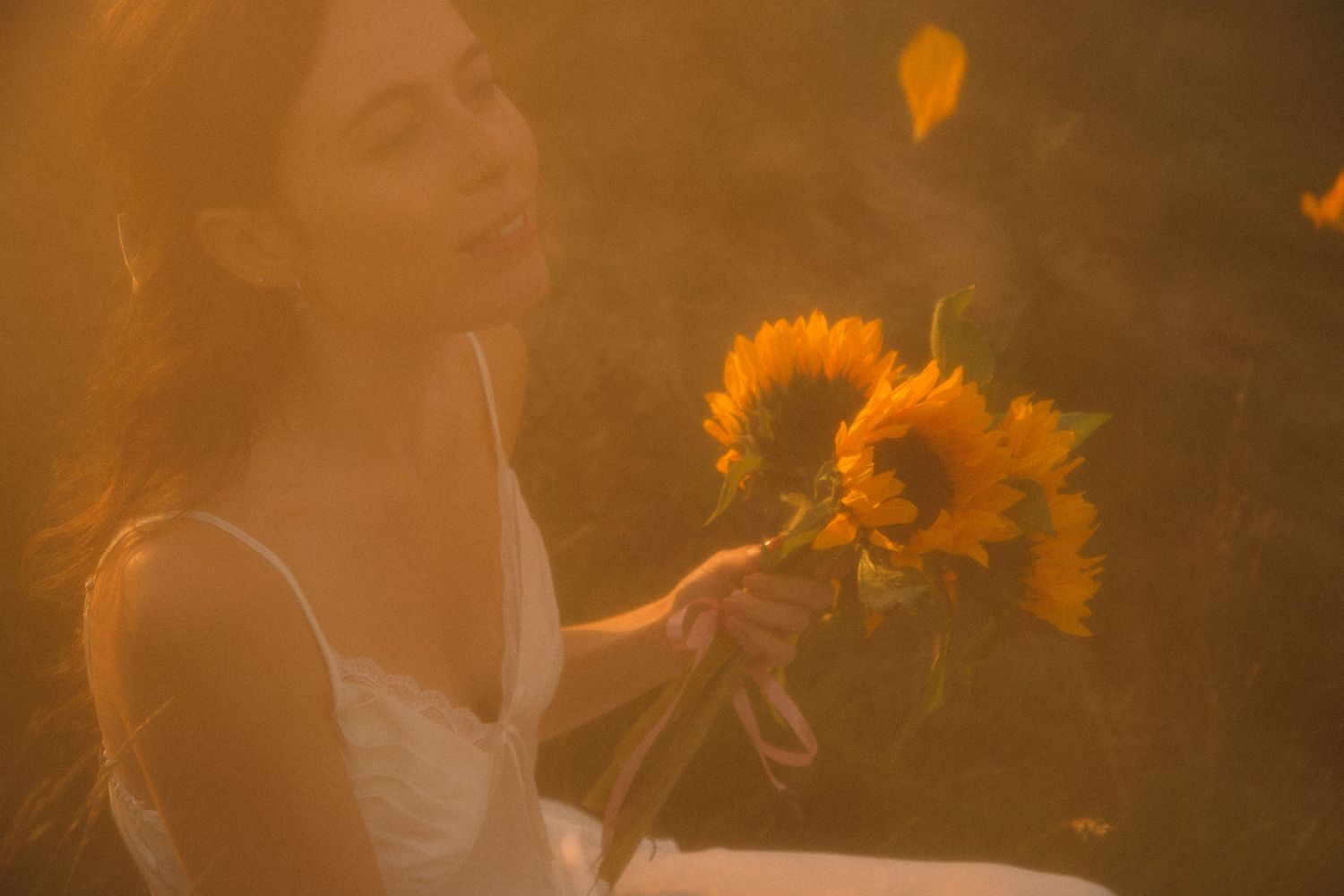 bride-throwing-petals-into-the-air-from-a-bouquet-of-sunflowers-at-golden-hour