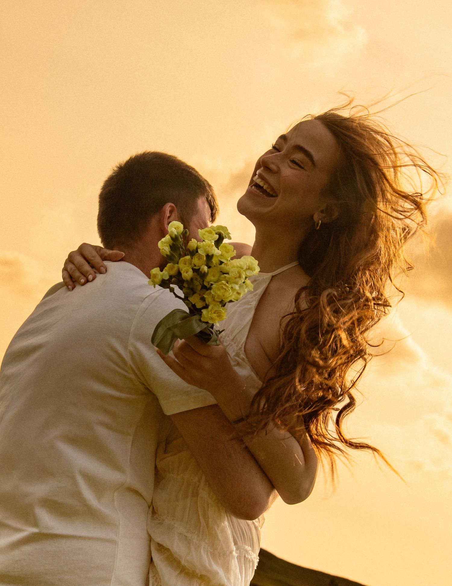 man-spinning-around-during-a-cinematic-golden-hour-photoshoot
